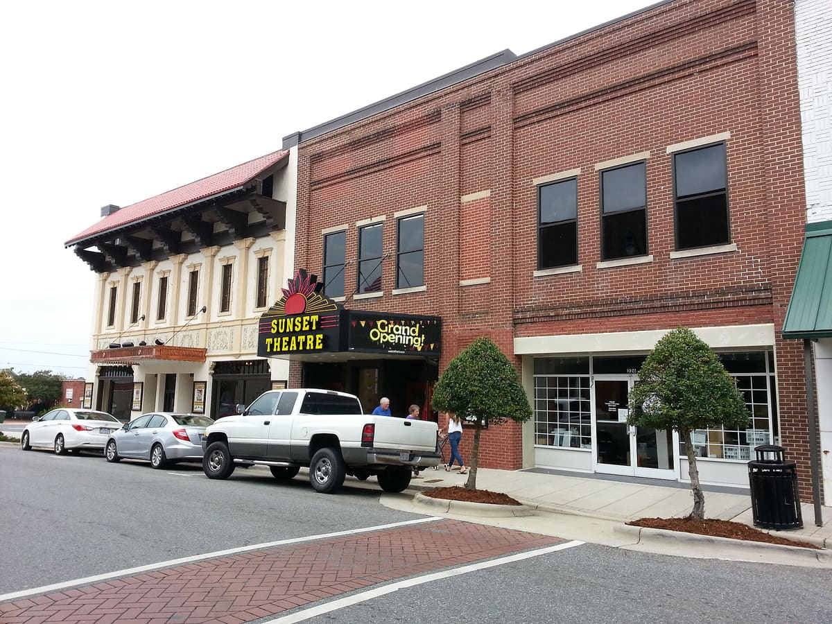 Historic brick storefronts and the Sunset Theatre marquee on Sunset Avenue in downtown Asheboro